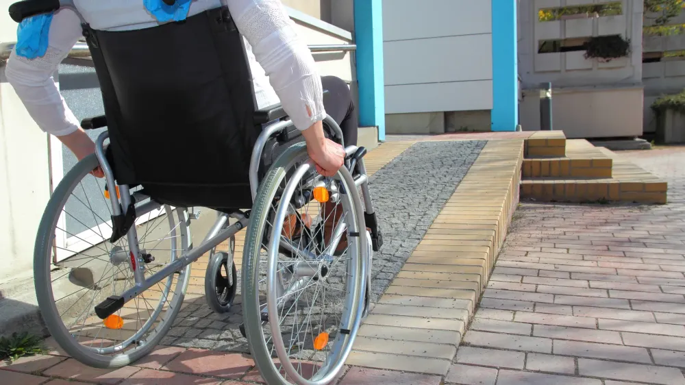 woman in wheelchair using ramp.